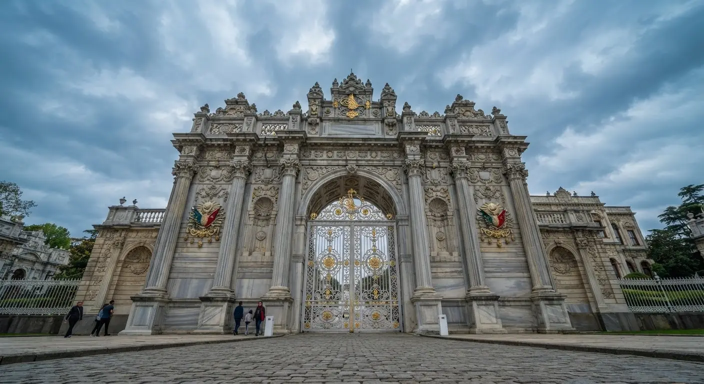 The Imperial Gate seen from below: wrought iron between richly carved stone pillars.